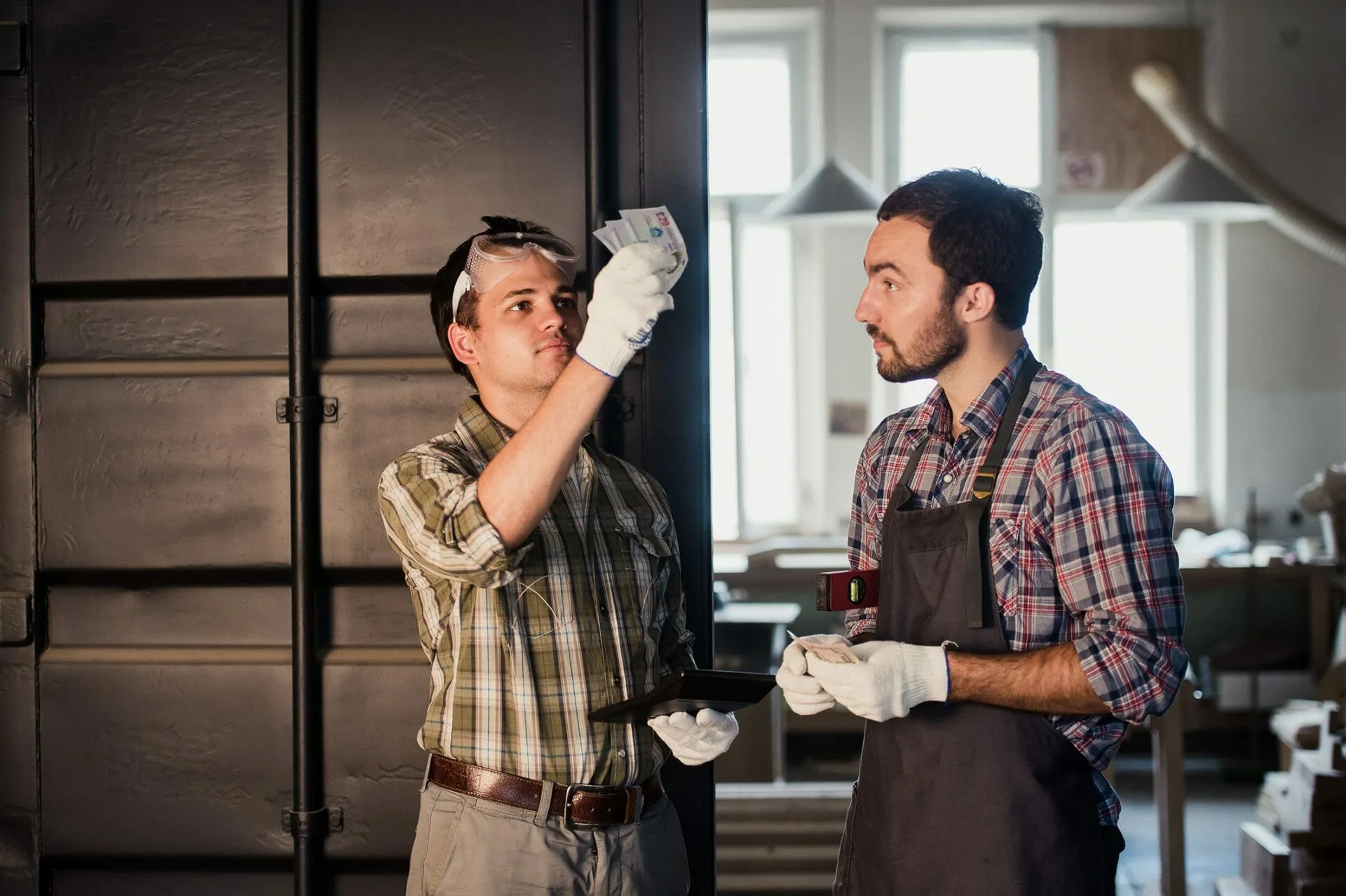 tradesman employee being paid cash in hand for work